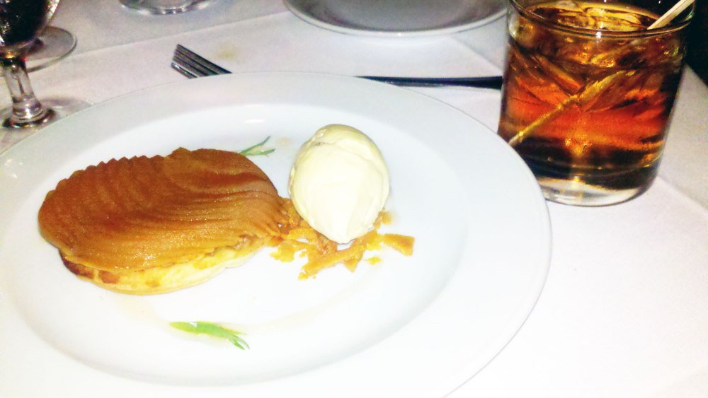 Apple Tarte Tartin over a Honey Crisp with Vanilla Rum Syrup and Rum Raisin Ice Cream.