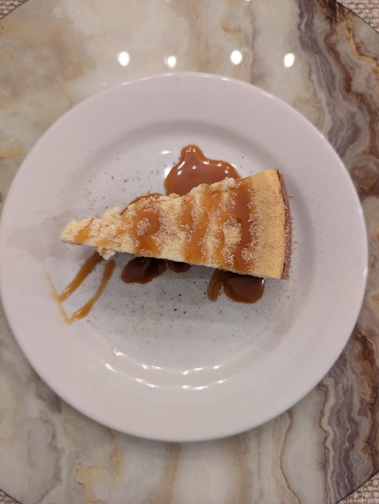 Eggnog Cheesecake with Pecan Sandie Crust and Bourbon Eggnog Carmel Drizzle