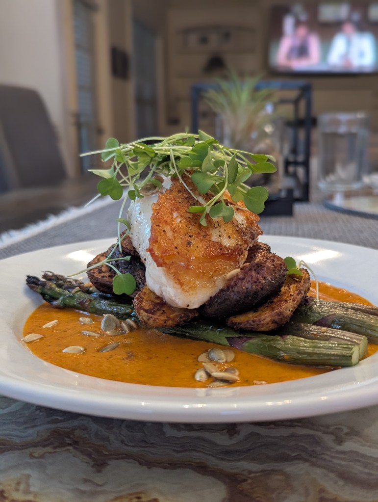 Seared Wreckfish, Crispy Fingerling Potatoes, Charred Asapargus with a Bell Pepper Sauce - Portrait, Close